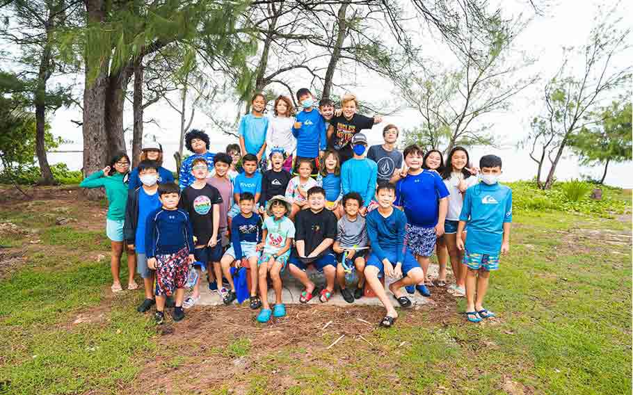 Summer campers take a group photo after a day of rod-and-reel fishing off the coast of Ypan for the 4-H Junior Fisheries Summer Camp in June 2022.
