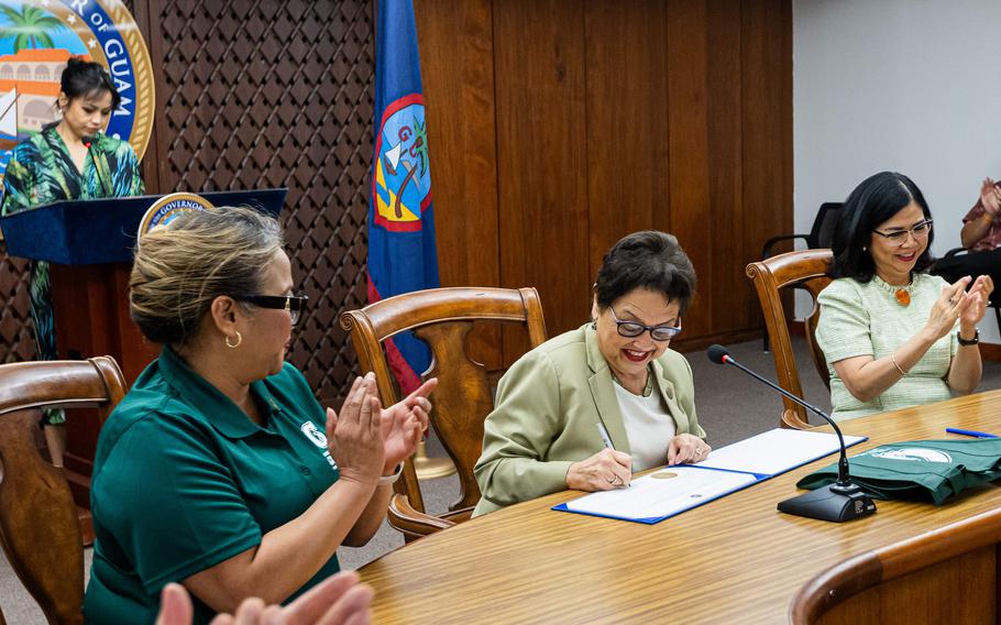 Gov. Lou Leon Guerrero, seated, front center, is joined by UOG President Anita Borja Enriquez, right, academic administrators, students, and staff during the ceremony at the Office of the Governor’s main conference room at Adelup proclaiming March as Charter Day Month for UOG.