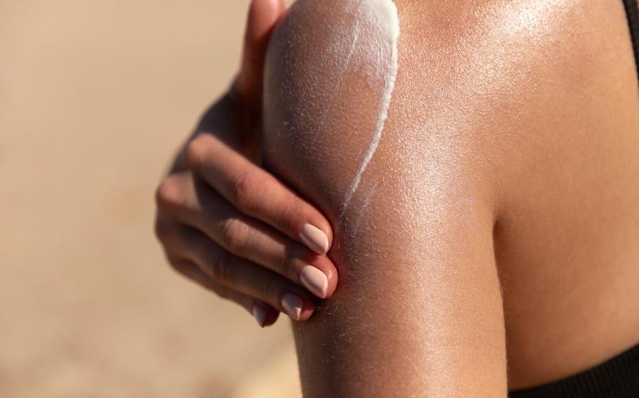 a person using sunscreen.