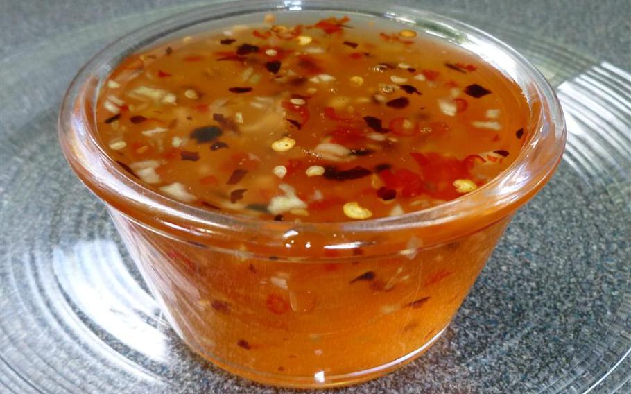 Sweet Chile Sauce in a plastic cup.