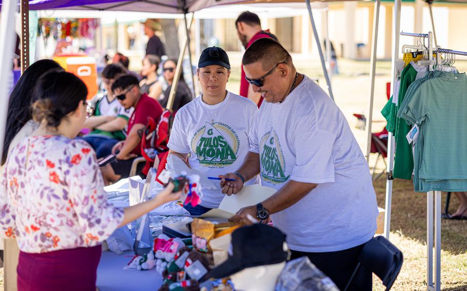 University of Guam Triton Store staff David Quintanilla (right) and Christine Concepcion (second from right) sell UOG logo merchandise at the 2024 Charter Day celebration. This year, over 50 vendors and 10 food trucks will be available at the Center Courtyard.