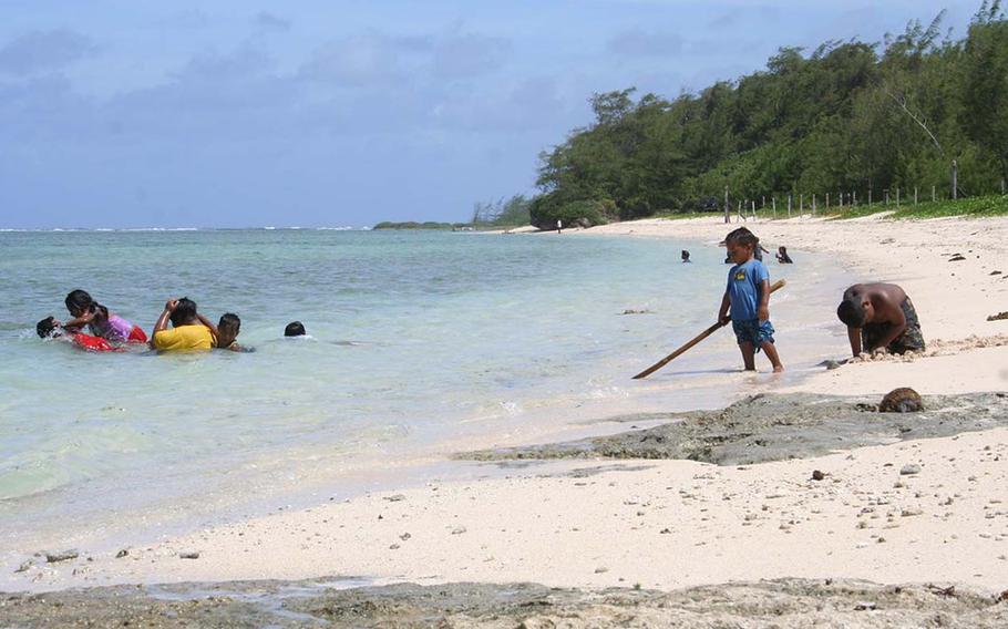 Kids frolic in the water and shore of Ipan Beach, a popular weekend area for families and friends.