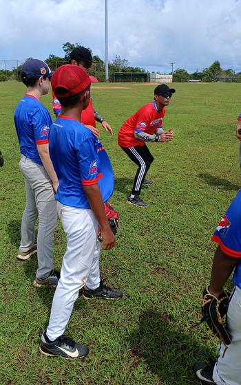 Tashiro teaching how to catch a fly ball.
