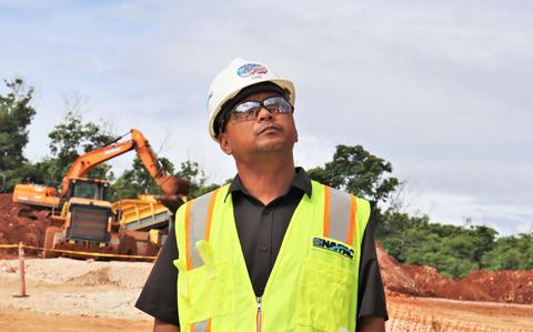 Photo Of Dean Cabe, a Safety Specialist with the Office in Charge of Construction (OICC) Marine Corps Marianas, checks the guardrail system of a roof under construction on a project site in northern Guam.