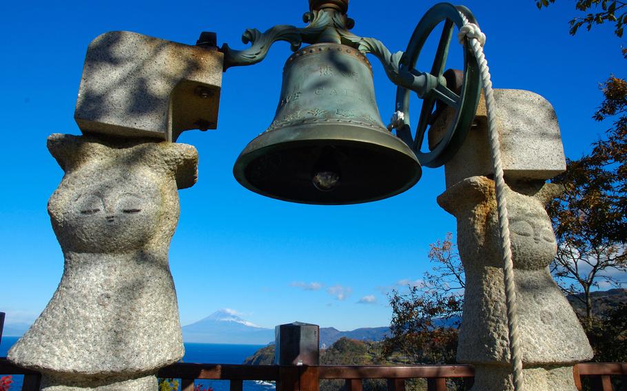 a bell attached to two statues at lovers’ point.