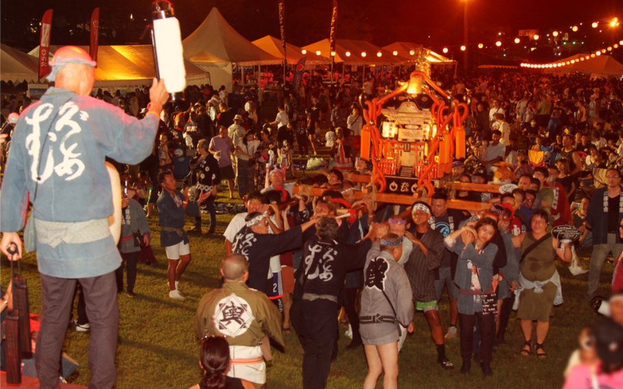 Participants are carrying a portable shrine during the festival.