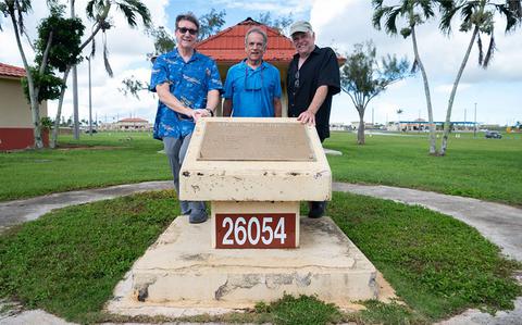 Photo Of In a sunny day, Jeff Meyer, 36th Wing base historian, Jeff Richard McGhie and Kevin Wright pose for a photo with a plaque listing the names of B-29 #44-61700 crew members at the Memorial Field on Andersen Air Force Base, Guam, August 26, 2024.