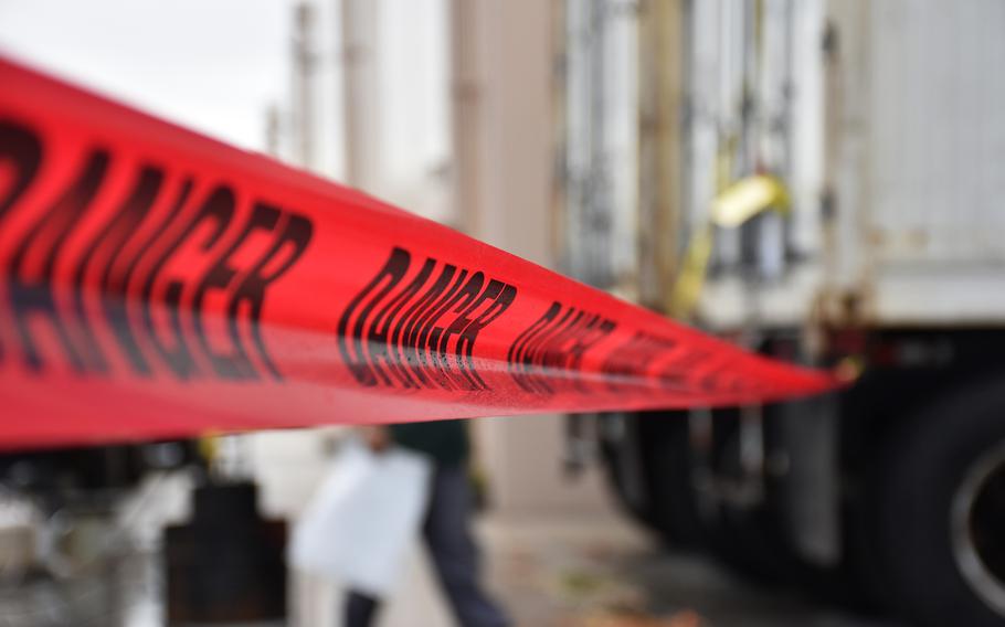 : Cautionary tape is placed around a safety buffer zone prior to the fumigation of a shipping container of fresh Christmas trees on Dec. 2, 2024 at a local business establishment in Tamuning.