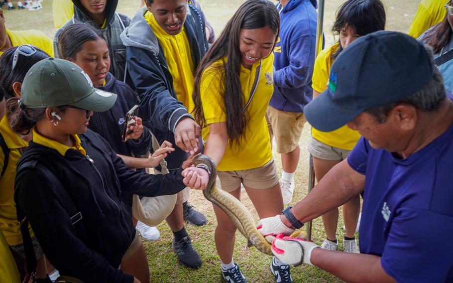 Students learn about brown tree snakes from the University of Guam Outreach and Extension exhibit at the 2024 UOG Charter Day celebration. Over 1,200 elementary to high school students from Guam’s public and private schools participated in campus tours during Charter Day last year.