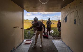 Soldiers from the Guam National Guard’s Team Binadu paint an exterior hallway at Adacao Elementary School in Dedeo, Feb. 7, 2024. Binadu, currently on active duty orders to defend Guam’s missile defense sites, hopes to accelerate the reopening of Guam’s public schools hit hardest by Typhoon Mawar.