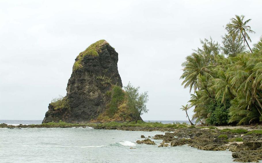 Fouha Rock can be seen on the beach. Palm trees also can be seen.