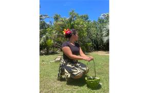 a woman stooping on the grass.