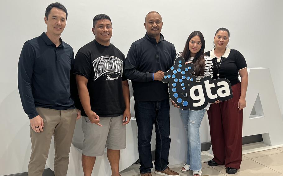 GTA staff members and some other people pose for a photo.