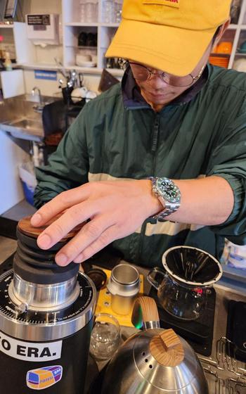 A staffer is making coffee.