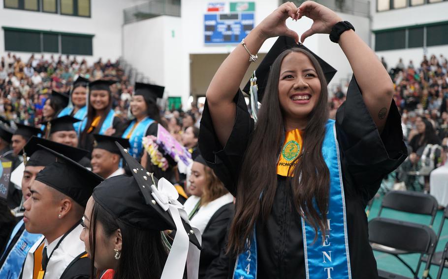 Elementary education major Naomi Jean Blas sends love to her family in the bleachers during the University of Guam Fanuchånan 2024 Commencement Ceremony on Dec. 15 at the Calvo Field House.