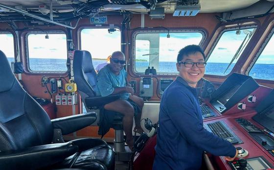 Photo Of Ensign Matt Go and Chief Robert Etiuweliug, chief of the community on Satawal, take a moment for a photo on the bridge of the USCGC Oliver Henry (WPC 1140), offshore of Satawal, Yap State, Federated States of Micronesia. The Oliver Henry crew hosted Chief Etiuweliug after safely returning six rescued fishermen and their 22-foot fiberglass boat to the community. 