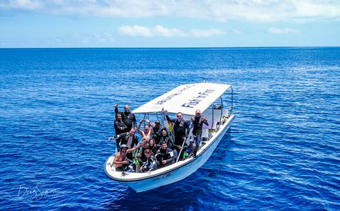 Photo Of there are some divers on the ship.