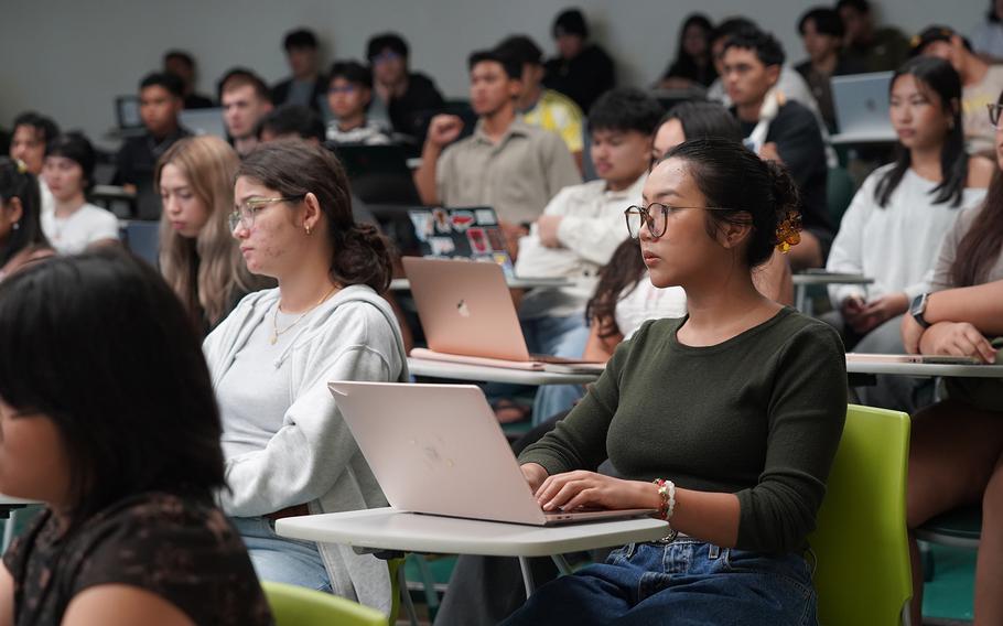 University of Guam students listen to a lecture during a science class.