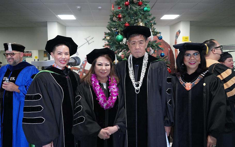 (From left) University of Guam Board of Regents Chair Lesley-Anne Leon Guerrero, commencement speaker Lisa Carbullido Henderson, UOG Board of Regents Treasurer Mike Naholowaa, and UOG President Anita Borja Enriquez prior to the Fanuchånan 2024 Commencement Ceremony on Dec. 15 in the Calvo Field House.