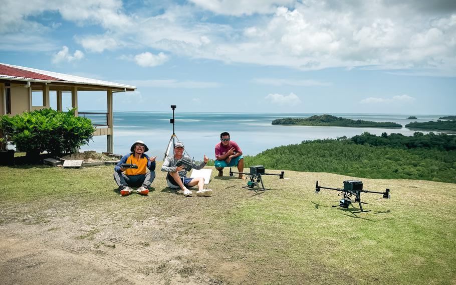 The mapping team poses with their fleet of DJI M350 RTK drones equipped with LiDAR sensors in Aimeliik, Palau.