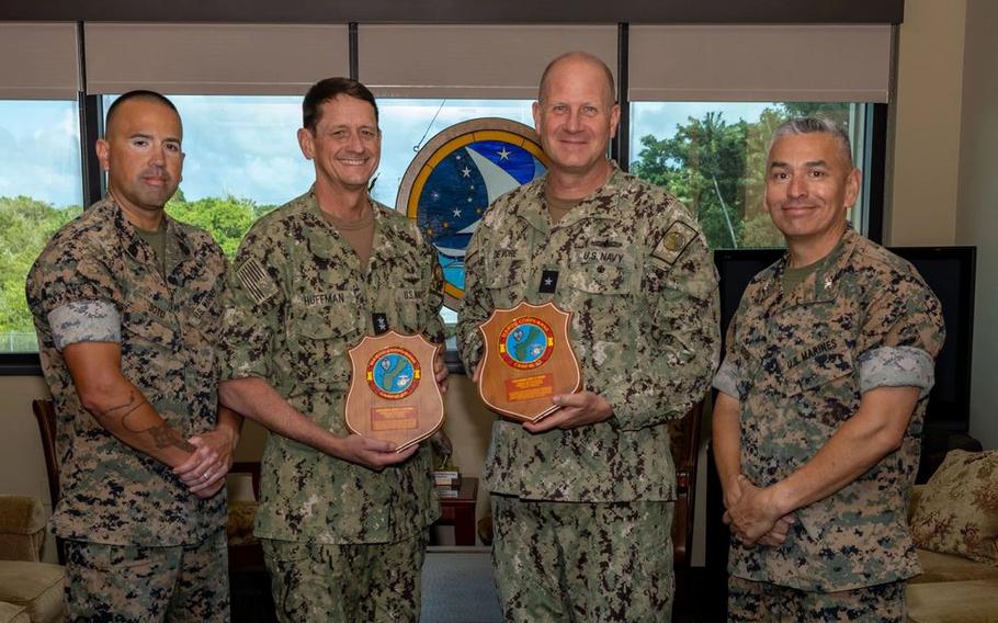 U.S. Marine Corps senior leaders with Marine Corps Base Camp Blaz and U.S. Navy Rear Adm. Gregory Huffman, commander, Joint Task Force-Micronesia and Rear Adm. Brent DeVore, commander, Joint Region Marianas, pose for a photo with the plaques presented by MCB Camp Blaz, Joint Region Marianas
 Headquarters, Guam, May 7, 2025. Camp Blaz leadership presented the plaques to show appreciation, highlighting their time spent at Joint Region Marianas.
