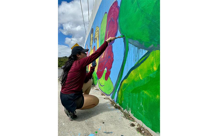 Artist Gera Datuin works on her mural in Hagatña as a member of the Guam Green Growth Art Corps.  Datuin is one of the many accomplished artists who joined the first cohort of the program. 