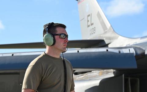 Photo Of Senior Airman Johnny Trail assists with pre-flight checks.