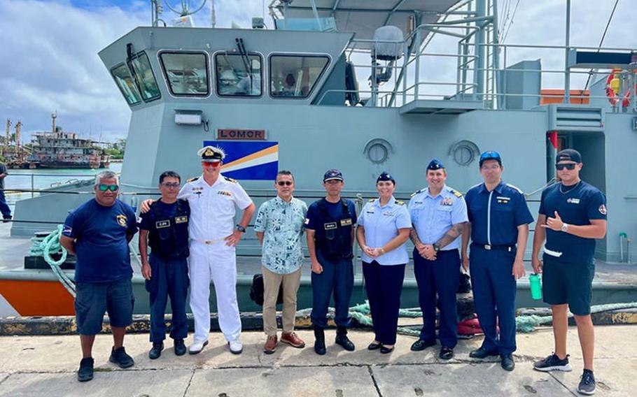 In Majuro, Republic of the Marshall Islands, on Jan. 26, 2024, U.S. Coast Guard Forces Micronesia/Sector Guam’s Cmdr. Ryan Crose, response department head, and Lt. Cmdr. Christine Igisomar, COFA maritime advisor, stand for a photo with Lt. Cmdr. Lachlan Sommerville, the Royal Australian Navy’s Maritime Security Advisor to the RMI Sea Patrol, and members of the RMI Sea Patrol. This visit marks a continuation of efforts to enhance the U.S. Coast Guard’s positive relationship with the Marshall Islands, particularly its maritime law enforcement entity, the RMI Sea Patrol.