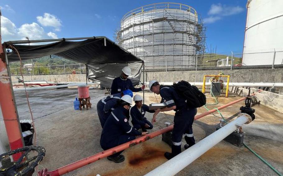 U.S. Coast Guard members observe a Government-Initiated Unannounced Exercise (GIUE) at Mobil Saipan on Feb. 29, 2024, in Saipan, Commonwealth of the Northern Mariana Islands. The primary goal of a GIUE is to ensure that the plan holder can effectively implement their response plan during a marine environmental response scenario.