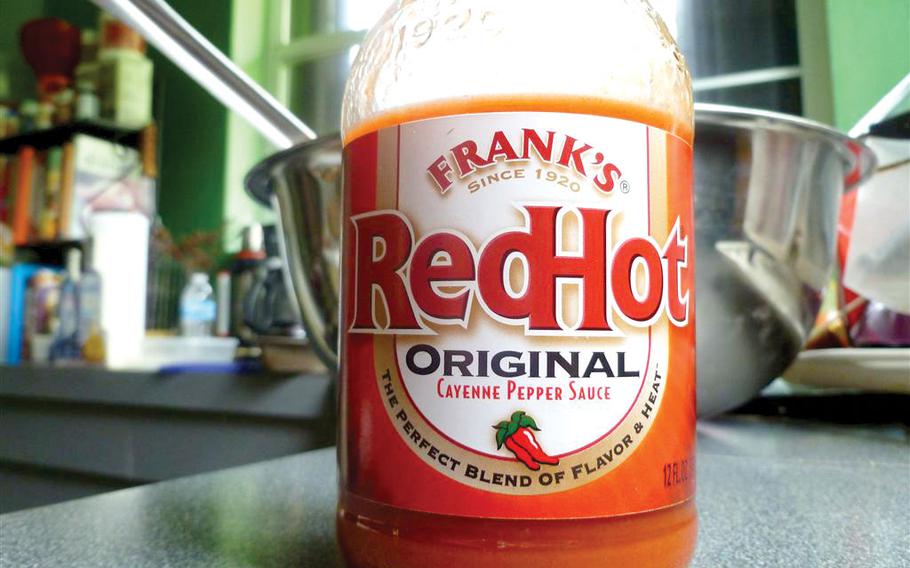 A full close-up photo of a bottle of hot pepper sauce.