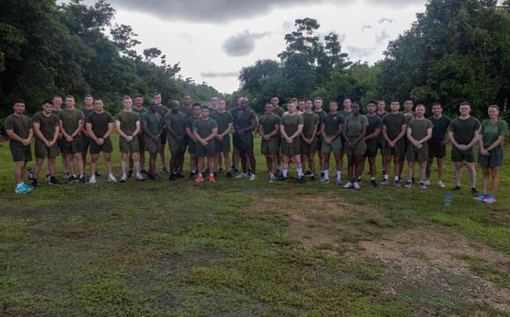 U.S. Marines with Headquarters Company, Marine Corps Base Camp Blaz, pose for a photo after a unit run to Tarague Beach on Andersen Air Force Base, Guam, Oct. 30, 2024. About 30 people are in the photo.