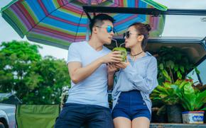 a couple is sharing coconut juice.