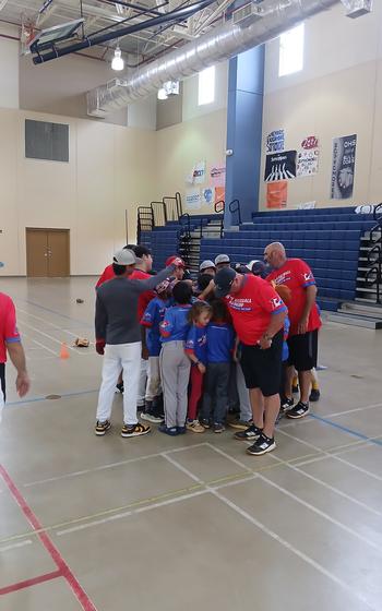 Coaches and childrean gathering around and form a circle.