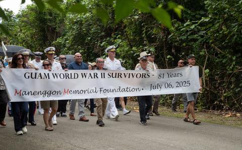 Photo Of U.S. service members, Guam residents, and supporters participate in a march to the Mañenggon Memorial Ceremony.
