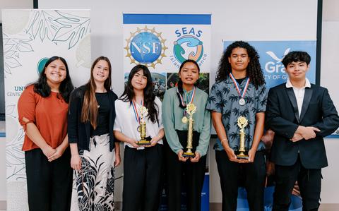 Photo Of Awardees pose for a photo.