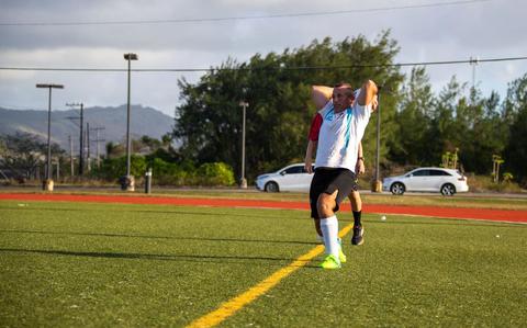 Photo Of U.S. Marine Corps Master Gunnery Sgt. Charles Hardesty, provost sergeant, Provost Marshal’s Office, Marine Corps Base Camp Blaz, takes a throw in during an intramural soccer game against Naval Hospital Guam at Naval Base Guam, Guam, April 30, 2025. 