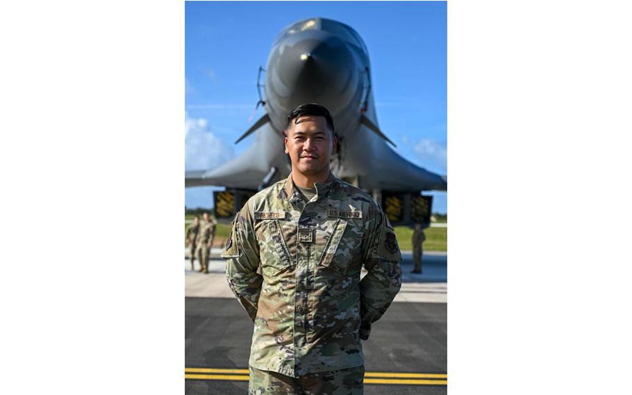 Senior Airman Michael Joel Pacheco poses in front of a B-1 Lancer.