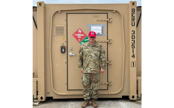U.S. Air Force Lt. Col. Matthew Mullinix, 513th Rapid Engineer Deployable Heavy Operations Repair Squadron Engineers Squadron physician’s assistant, poses in front of his medical clinic at Tinian North Field, Tinian, April 23, 2025. Mullinix’s clinic is capable of treating and stabilizing trauma patients in the event of an accident taking place during the rehabilitation of Tinian North Field. 