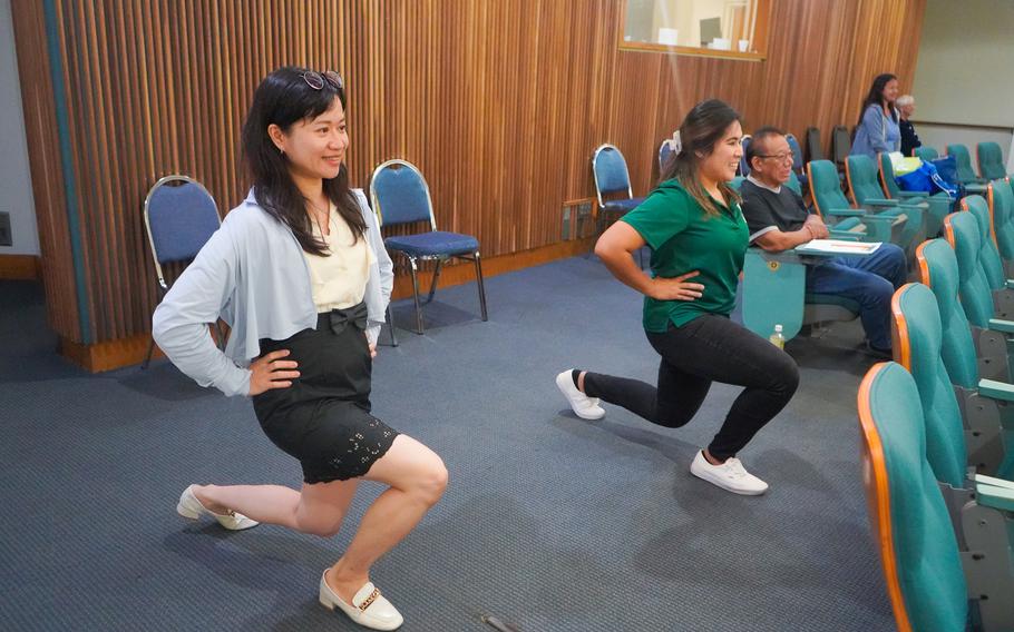 Residents practice some simple strength and stretching exercises that can be done at home during a session of the UOG Farmer Focus Health Seminar held in August 2024 at the University of Guam.