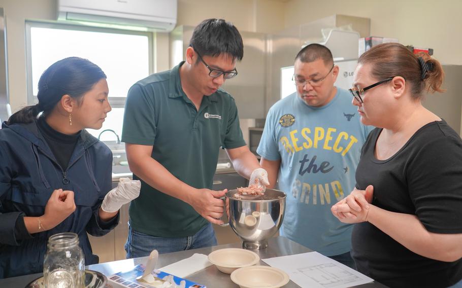 University of Guam Land Grant meat scientist Dr. Jeng-Hung Liu inspects the consistency of pork to be turned into sausage during a meat processing workshop held in August 2023 at UOG. (From left) Rita Barcinas, Liu, Marvin Crisostomo, and Christina Crisostomo.
