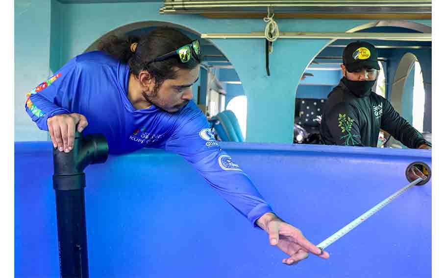 Members of the UOG Center for Island Sustainability and Sea Grant aquaculture team Lawrence Lizama and Joshua Muña prepare the installation of the first Community Based Aquaponics System (CBAS).