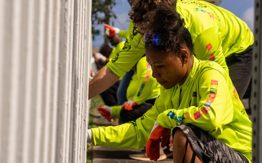 Members of the Guam Green Growth Conservation Corps cleaning the wall.