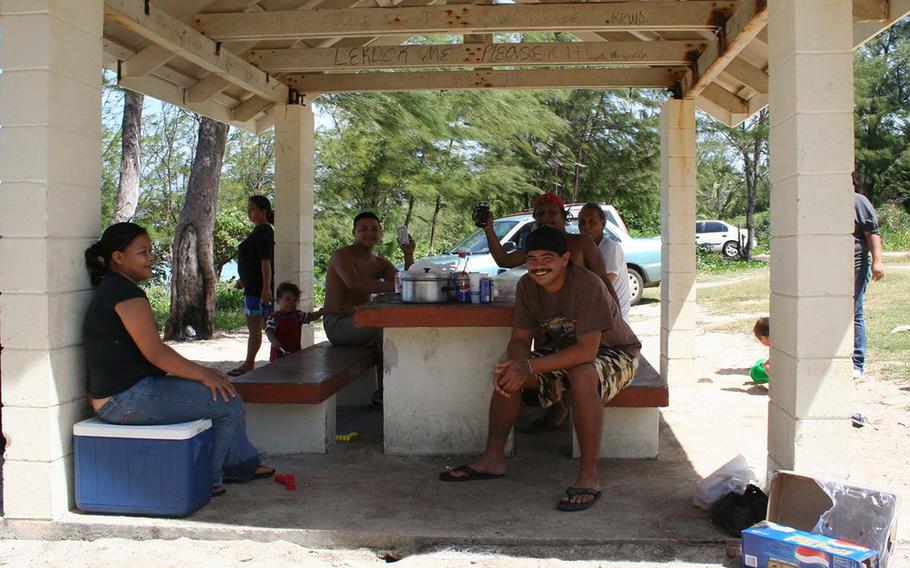 A family gathers under a pavilion in Ipan Beach Park to celebrate the beginning of summer.