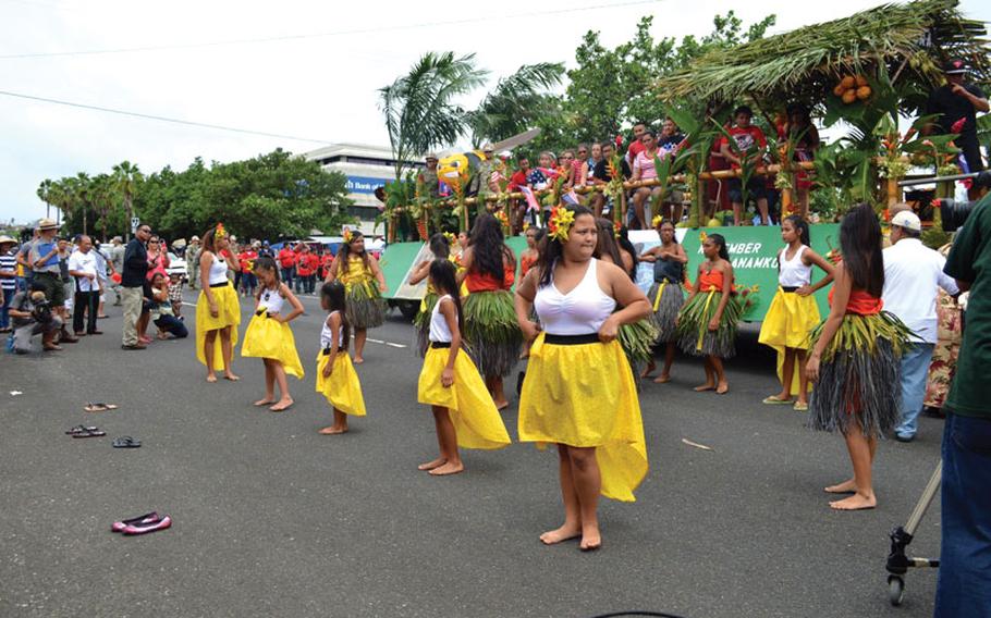 Women are dancing on the road to celebrate Liberty Day.