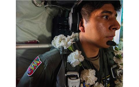 Photo Of U.S. Air Force Airman 1st Class Anthony Gonzalez stands during a flight honoring U.S. Air Force Senior Airman Jeremy Jutba.