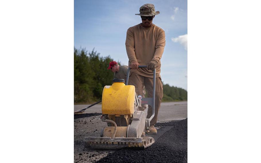 Airman 1st Class Jhunel Binoya, 554th Rapid Engineering Deployable Heavy Operations Repair Squadron Engineer heavy equipment and pavement specialist, uses a stamper machine to smooth out fresh asphalt on Naval Base Guam’s flight line, Feb. 8, 2024. The 554th REDHORSE have been hard at work for a week clearing and rehabilitating the flight line on NBG. Their efforts are part of a larger plan to expand aircraft capabilities on Guam as simultaneous flight line rehabilitation efforts occur on Pacific Regional Training Center - Andersen, Guam.