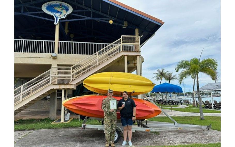 Stars and Stripes Pacific Commander Lt. Col. Marci Hoffman presenting Best on-base outdoor rec award to Naval Base Guam Rec-N-Crew Outdoor Recreation staff.