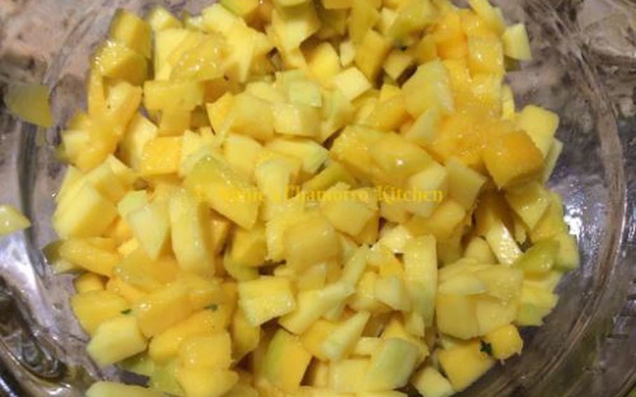 Cut the skin off the mango. Dice the mango into 1/4-inch cubes.
Place into a small mixing bowl.
