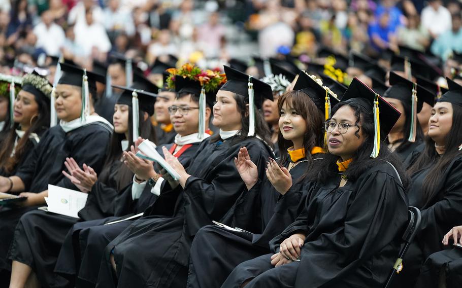 Venaure Kanai, right, and her fellow Master of Science in Clinical Psychology graduates listen to the commencement address on Dec. 15 in the UOG Calvo Field House.