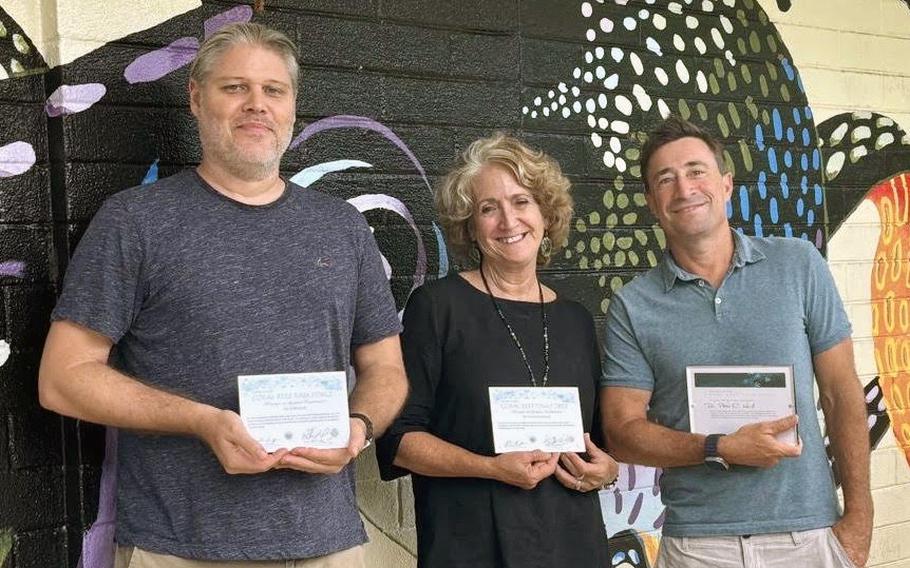 (From left) University of Guam Marine Lab Research Associate David Burdick; Marine Lab Director and Professor of Marine Biology Laurie Raymundo; and Professor of Marine Biology Peter Houk hold the Outstanding Service Awards they each received from the U.S. Coral Reef Task Force for their individual projects preserving and protecting coral reef ecosystems.